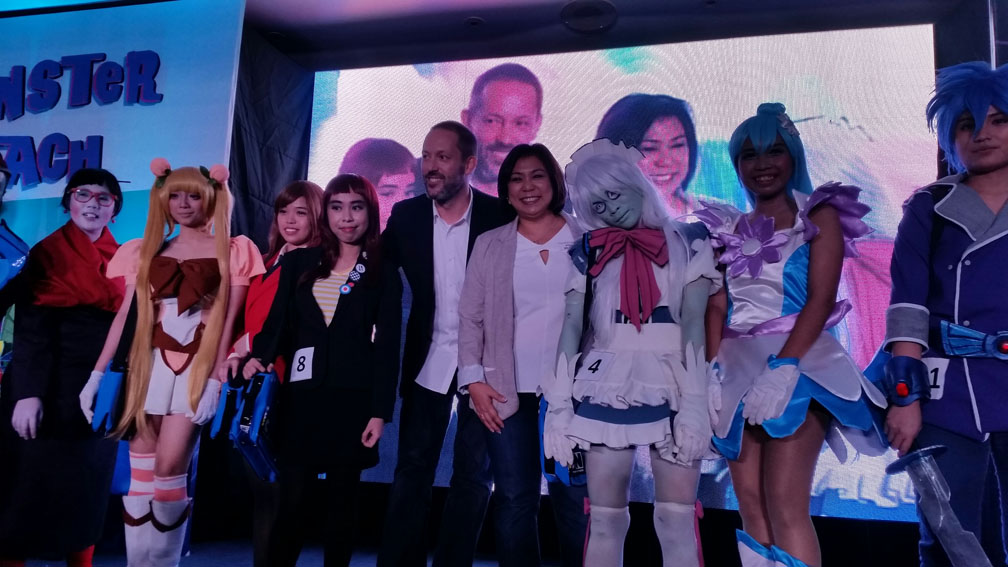 Silas Hickey of Cartoon Network with Stella Dearing of Top Draw Animation posing with Exchange Student Zero cosplayers from her team.jpg