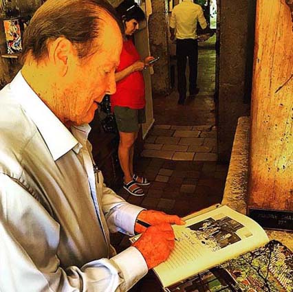 Sir Roger Moore signs CBs book.jpg