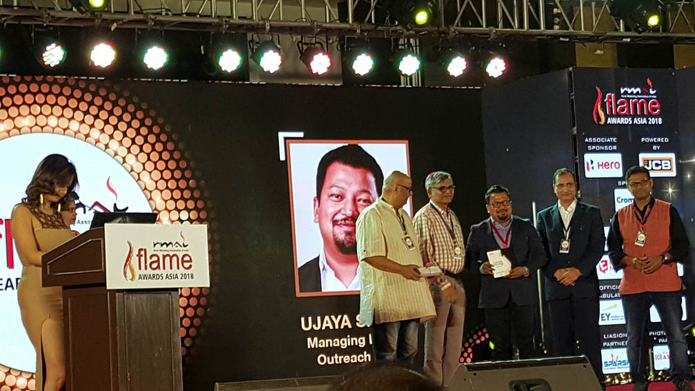 Ujaya receiving award.jpg